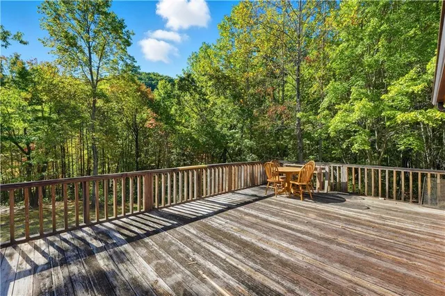a view of balcony with wooden floor and fence