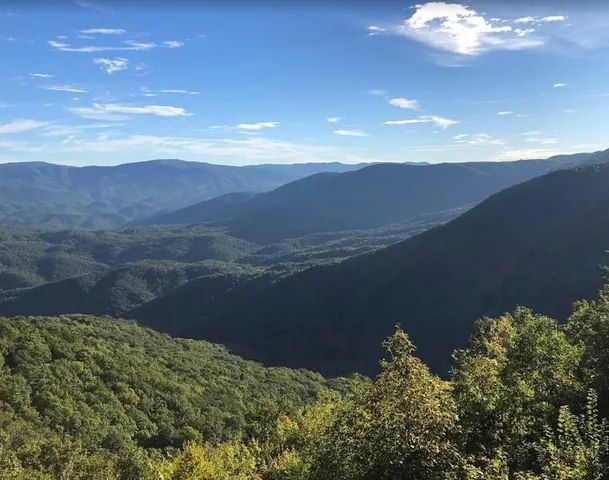 a view of a balcony with wooden floor and fence