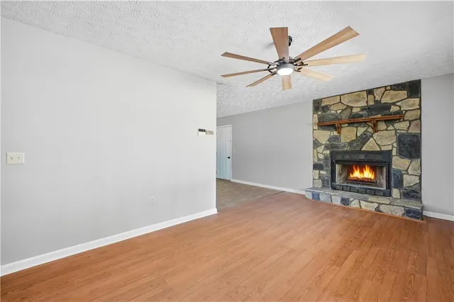 an empty room with fan and windows