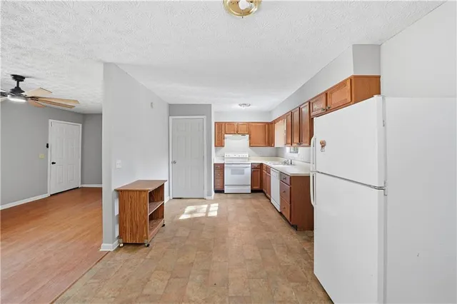 a kitchen with a refrigerator sink stove and cabinets