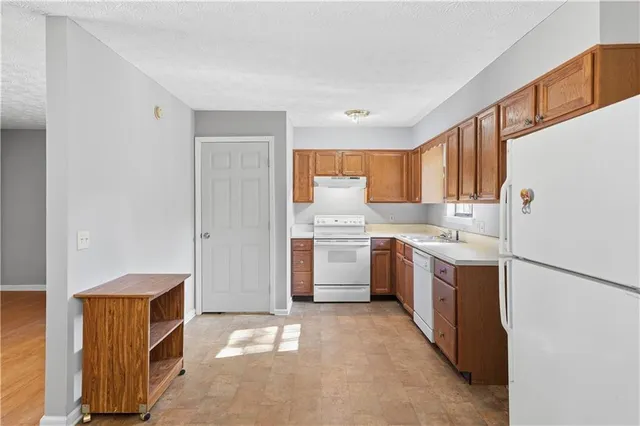 a kitchen with a sink a counter top space and stainless steel appliances