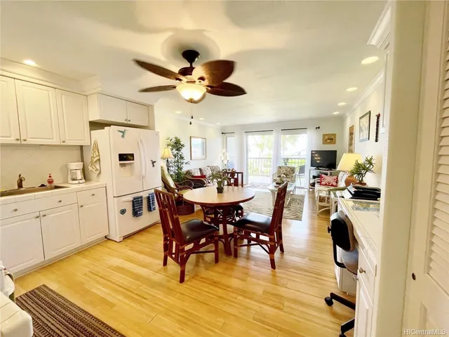 a view of a dining room with furniture and a chandelier