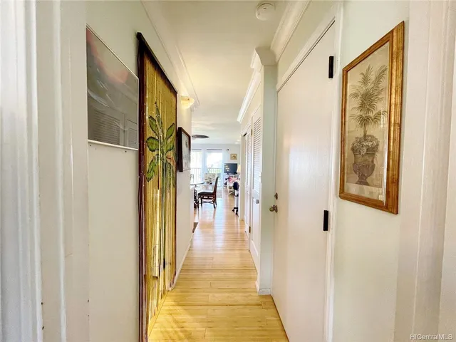 a view of a hallway with wooden floor and a hallway