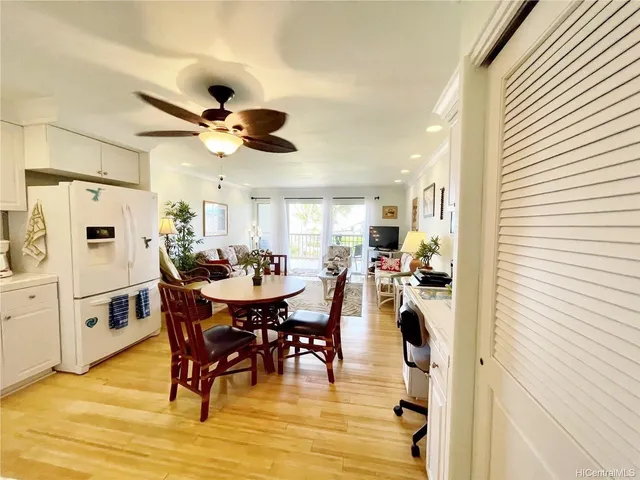 a view of a dining room with furniture and a chandelier