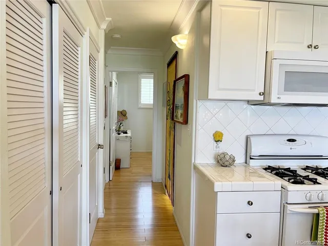 a kitchen with a stove a refrigerator and a cabinets