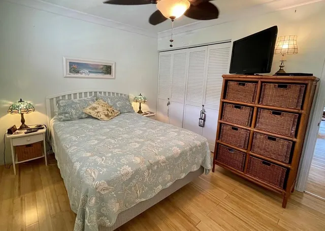 a bedroom with a bed and flat screen tv
