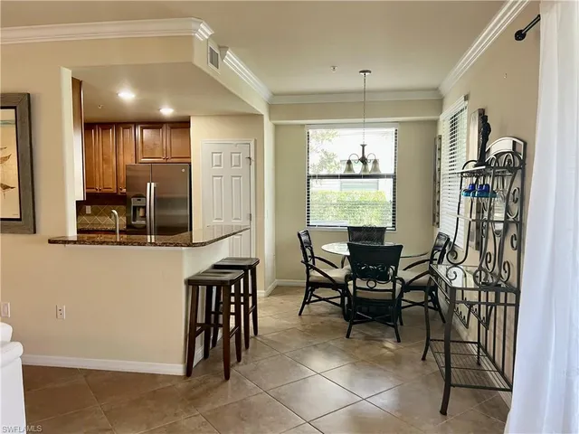 a view of a a dining room with furniture window and wooden floor