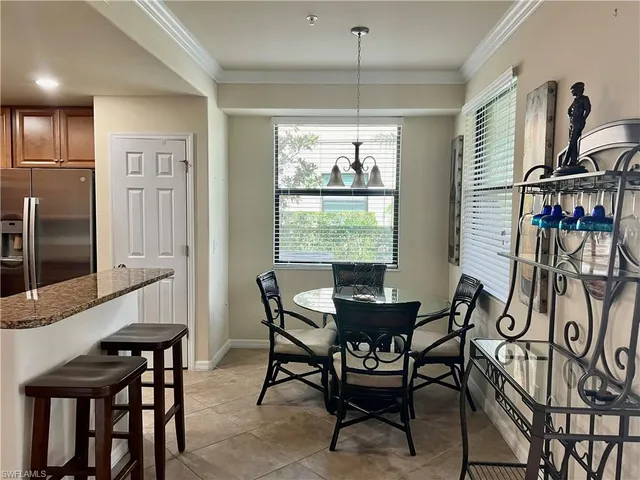 a view of a dining room with furniture window and outside view