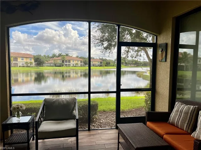a balcony with furniture and a floor to ceiling window