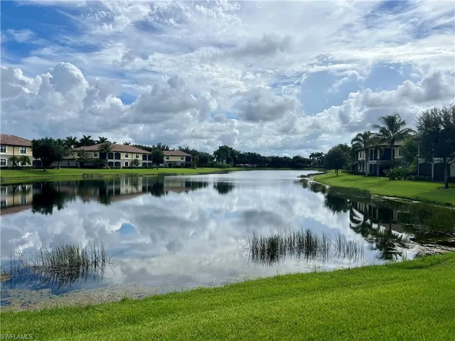 a view of a lake with houses in the background