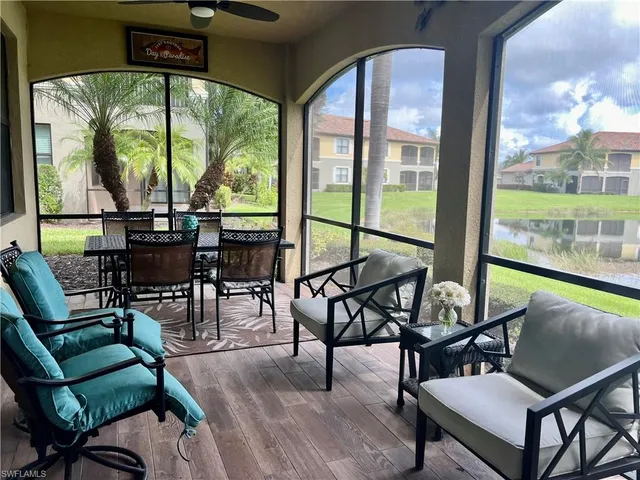 a view of a chairs and table in patio and yard