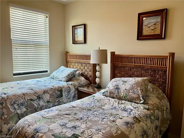 a bedroom with two beds and a window