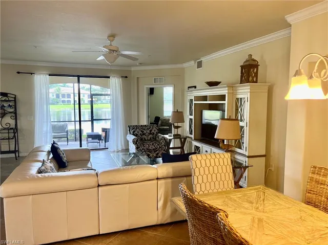 a living room with furniture fireplace and flat screen tv