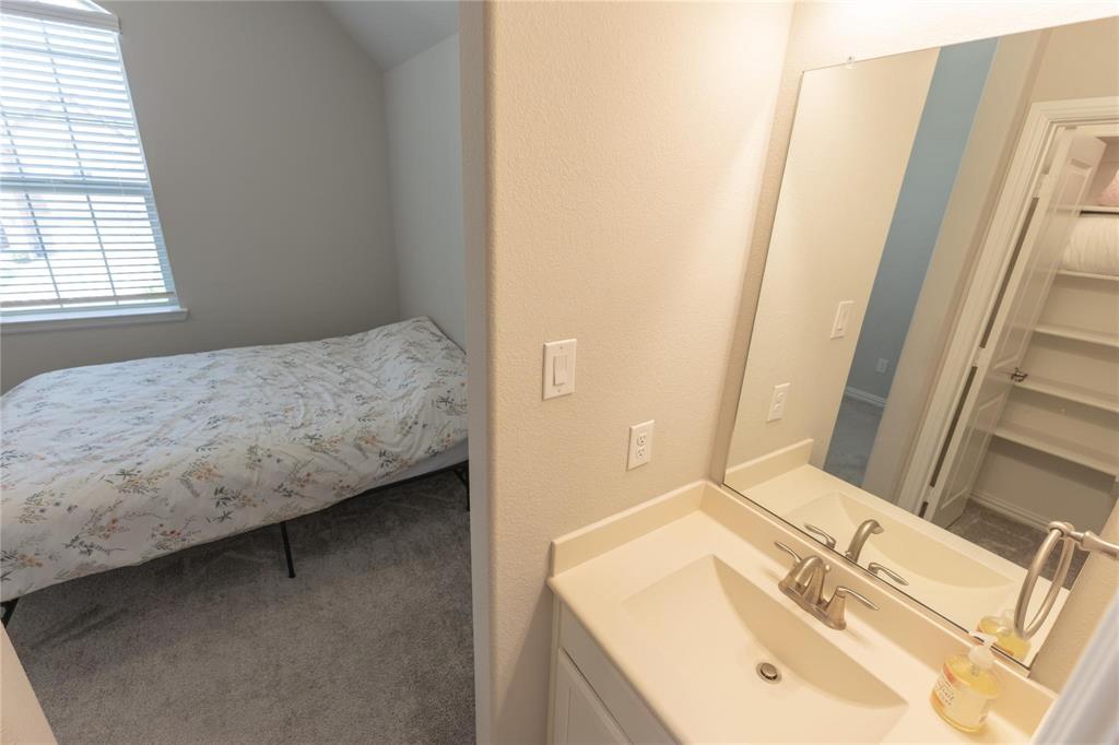 3920 Bentgrass Road Plano, TX 75023 - Photo 27 of 30 a bedroom with a sink and a mirror