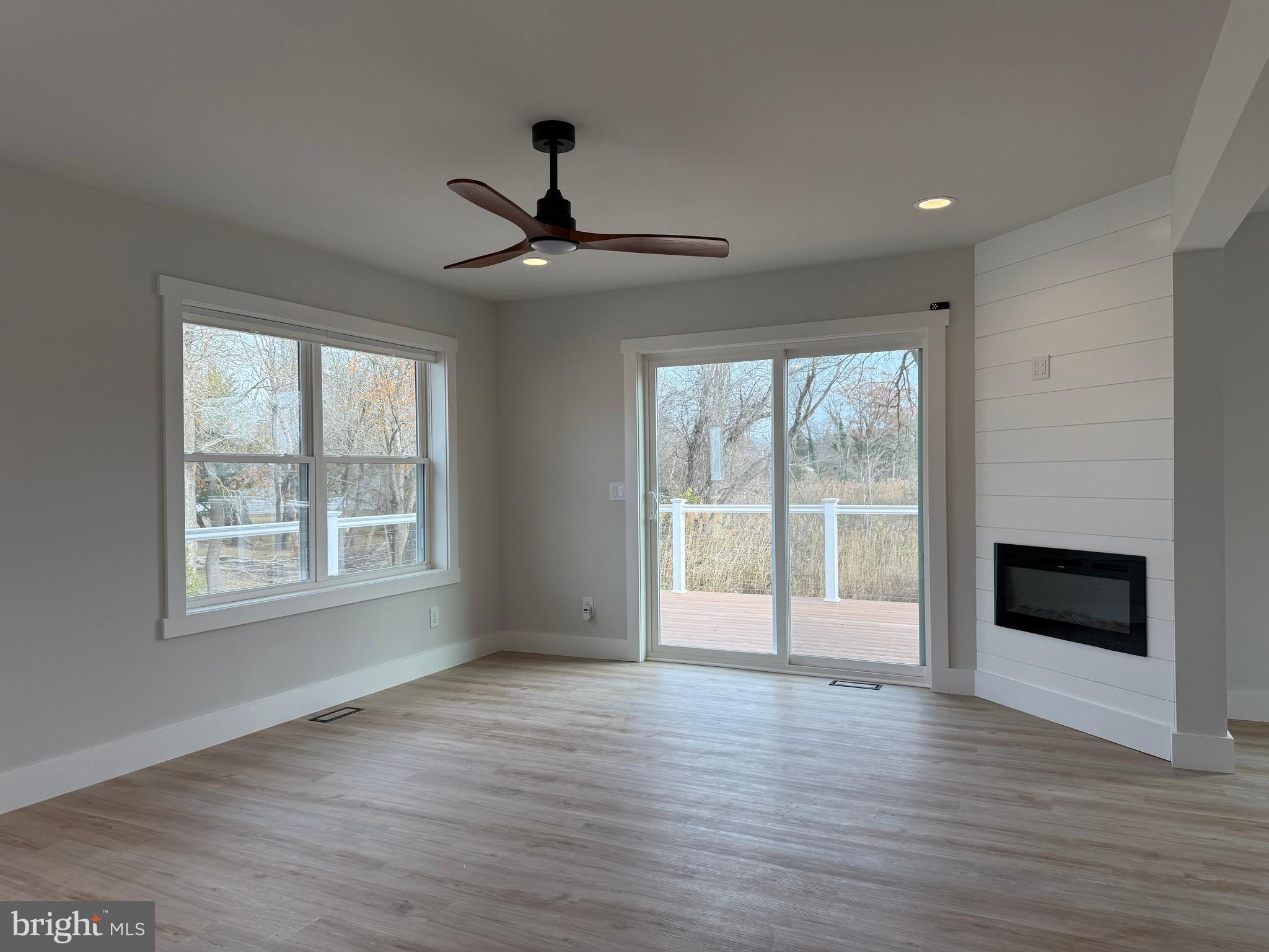 44 A Cedar Beach Road Milford, DE 19963 - Photo 2 of 15 a view of an empty room with a window and wooden floor