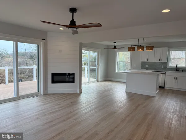 a view of a kitchen with a sink wooden floor and a window