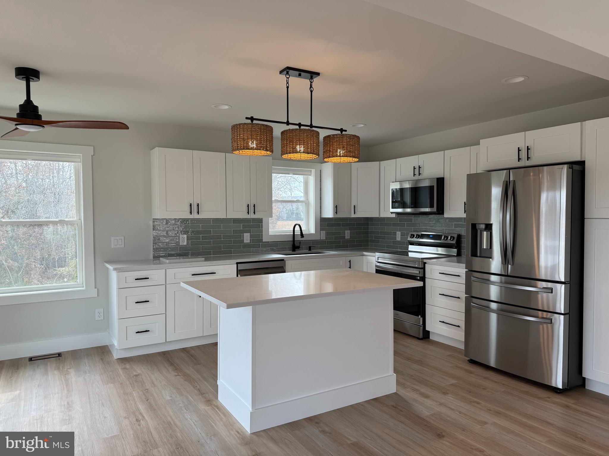 44 A Cedar Beach Road Milford, DE 19963 - Photo 4 of 15 a kitchen with white cabinets stainless steel appliances and window