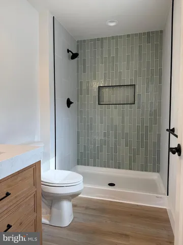 a bathroom with a toilet and a shower