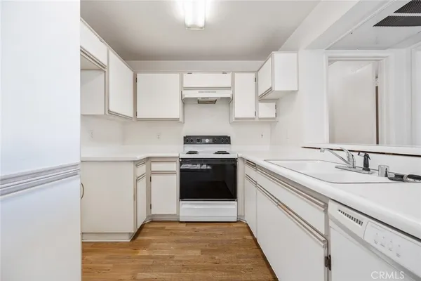 a kitchen with a white cabinets and white appliances