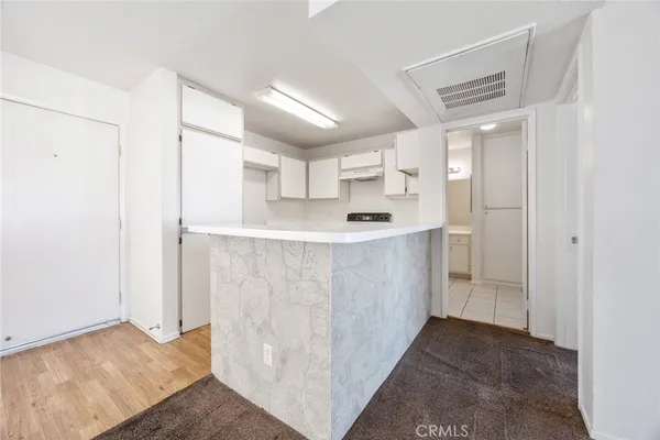 a view of a kitchen with white cabinets