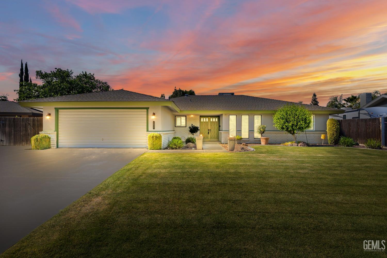 a front view of a house with a garden
