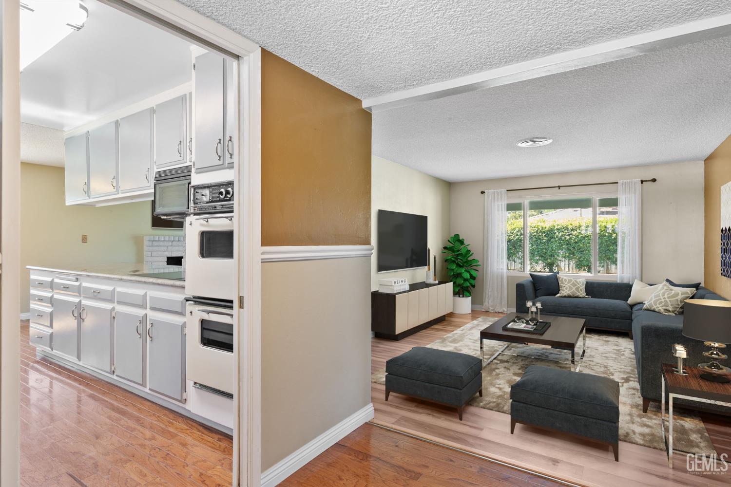 Undisclosed Address Bakersfield, CA 93309 - Photo 11 of 63 a living room with furniture and a flat screen tv