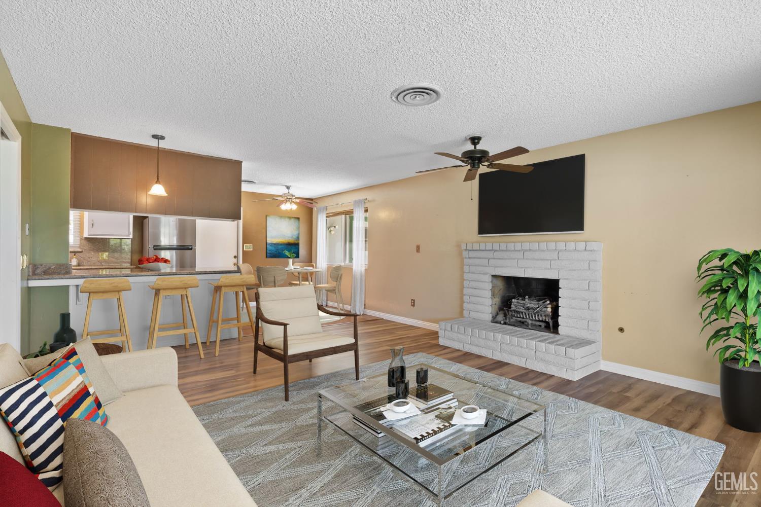 Undisclosed Address Bakersfield, CA 93309 - Photo 15 of 63 a living room with furniture and a fireplace