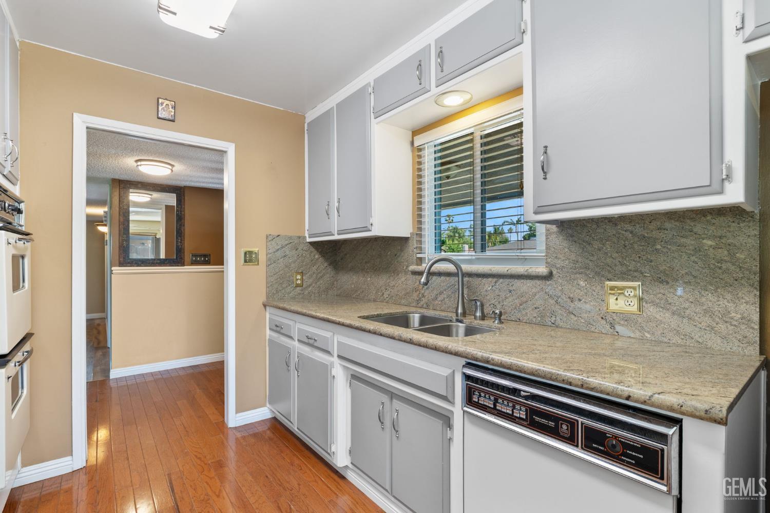 Undisclosed Address Bakersfield, CA 93309 - Photo 19 of 63 a kitchen with a sink stove and cabinets