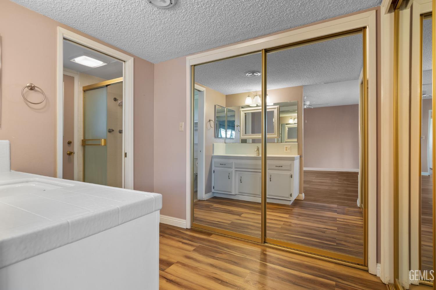 Undisclosed Address Bakersfield, CA 93309 - Photo 25 of 63 a view of a hallway with wooden floor