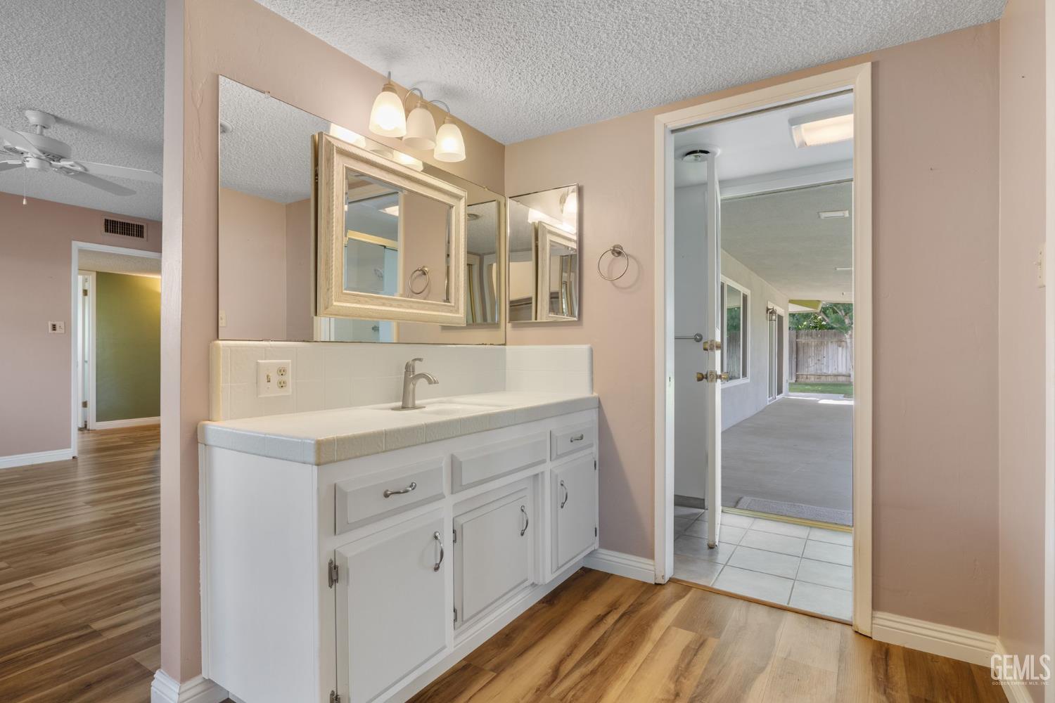 Undisclosed Address Bakersfield, CA 93309 - Photo 26 of 63 a spacious bathroom with a double vanity sink a mirror and a shower