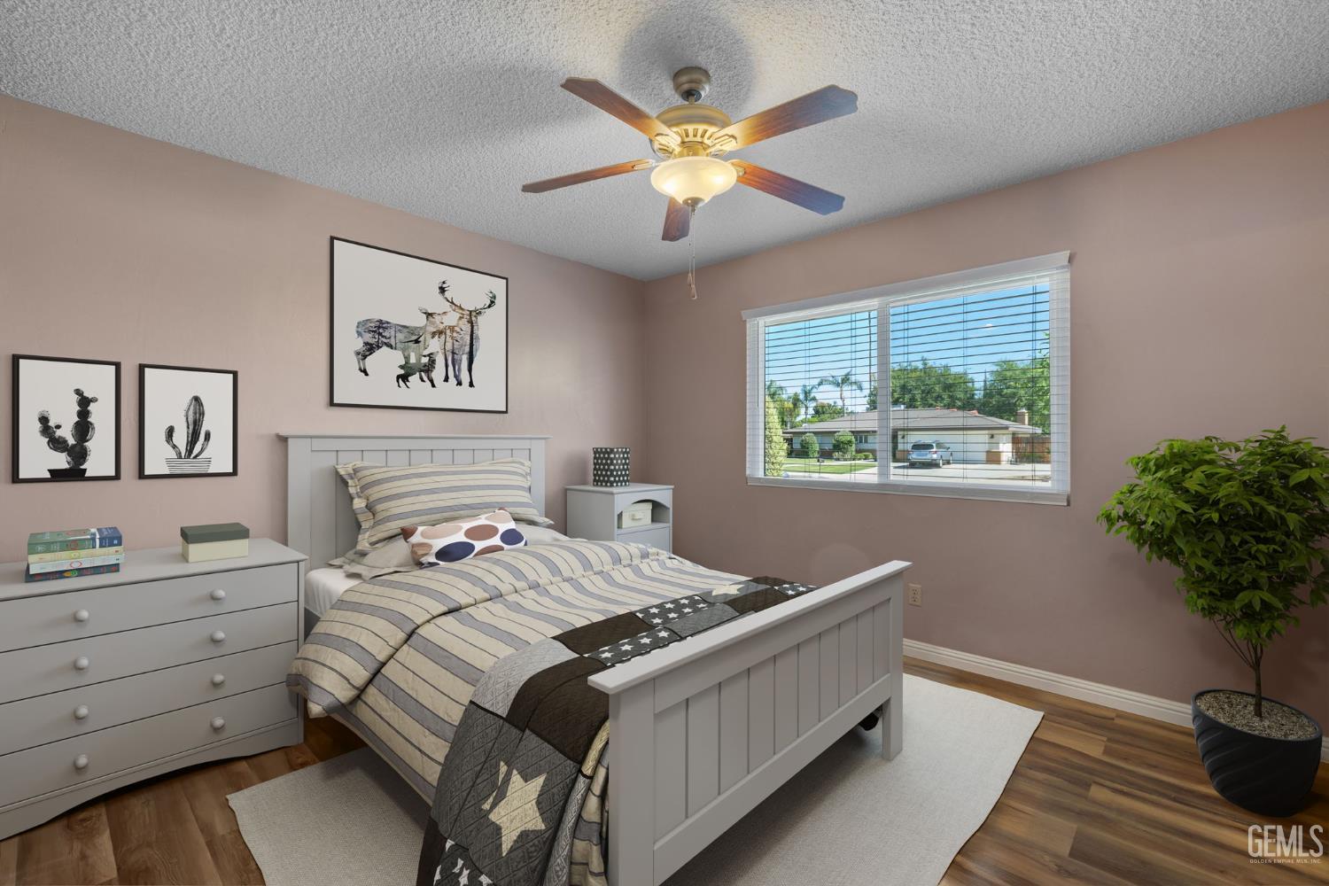 Undisclosed Address Bakersfield, CA 93309 - Photo 27 of 63 a bedroom with a bed and a potted plant