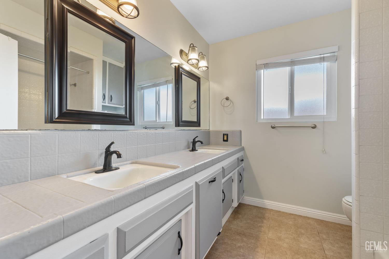 Undisclosed Address Bakersfield, CA 93309 - Photo 29 of 63 a bathroom with a sink and a mirror