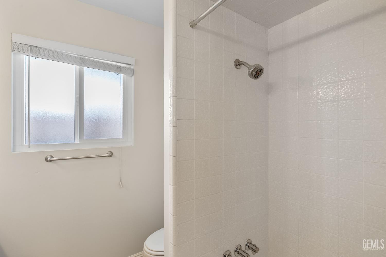 Undisclosed Address Bakersfield, CA 93309 - Photo 30 of 63 a bathroom with a granite countertop toilet and a shower