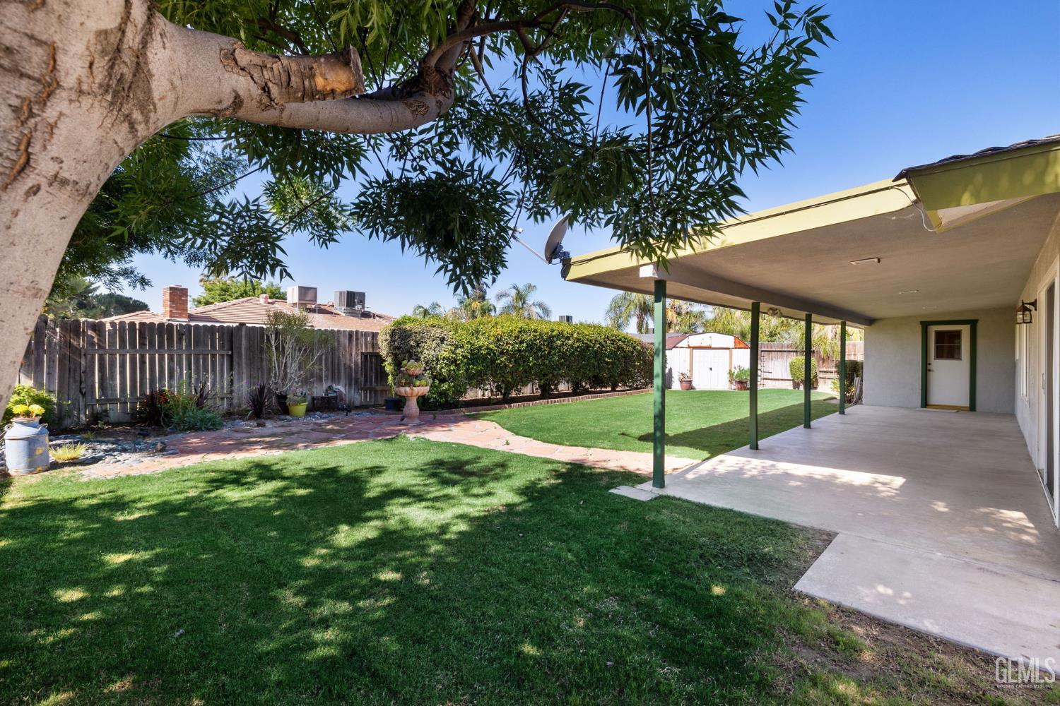 Undisclosed Address Bakersfield, CA 93309 - Photo 32 of 63 a view of a house with backyard and a garden