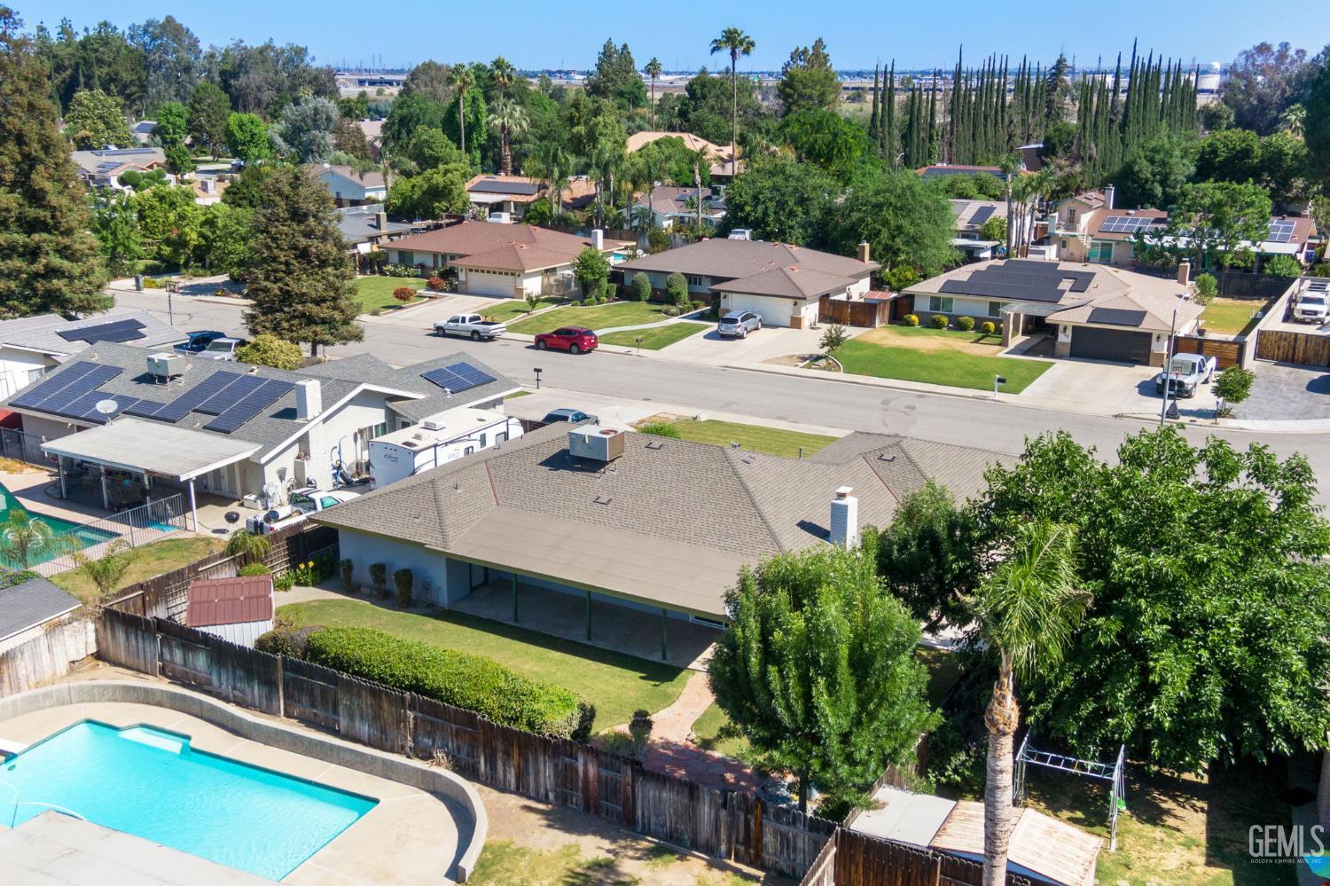 Undisclosed Address Bakersfield, CA 93309 - Photo 38 of 63 a view of a swimming pool with a patio and a garden
