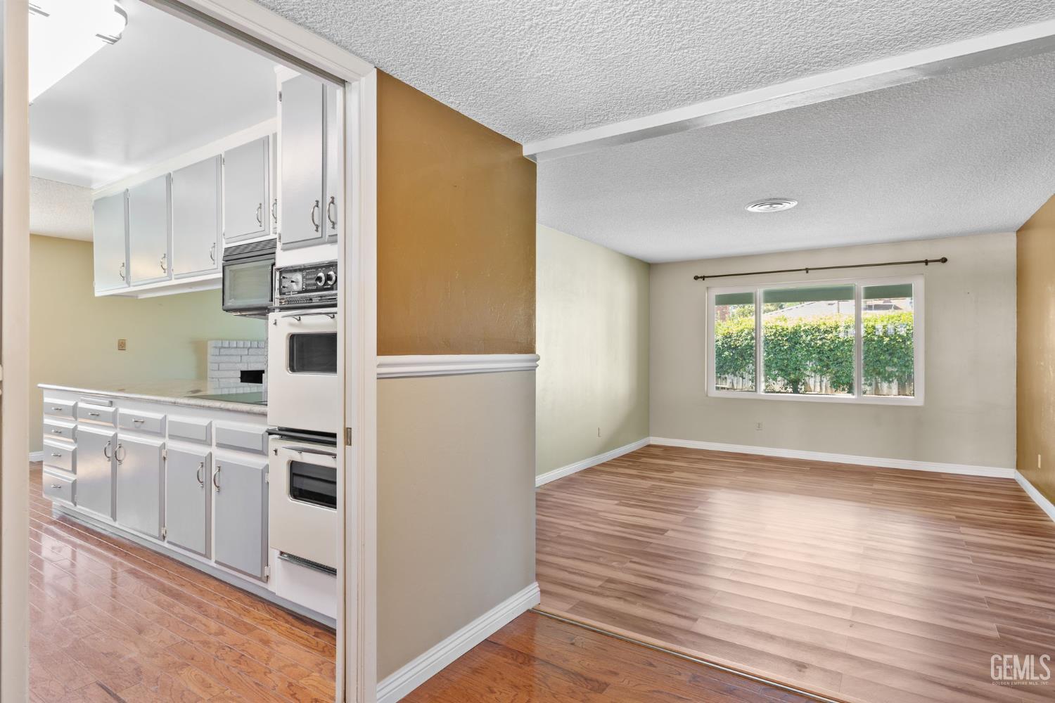 Undisclosed Address Bakersfield, CA 93309 - Photo 41 of 63 a kitchen with white cabinets and white appliances