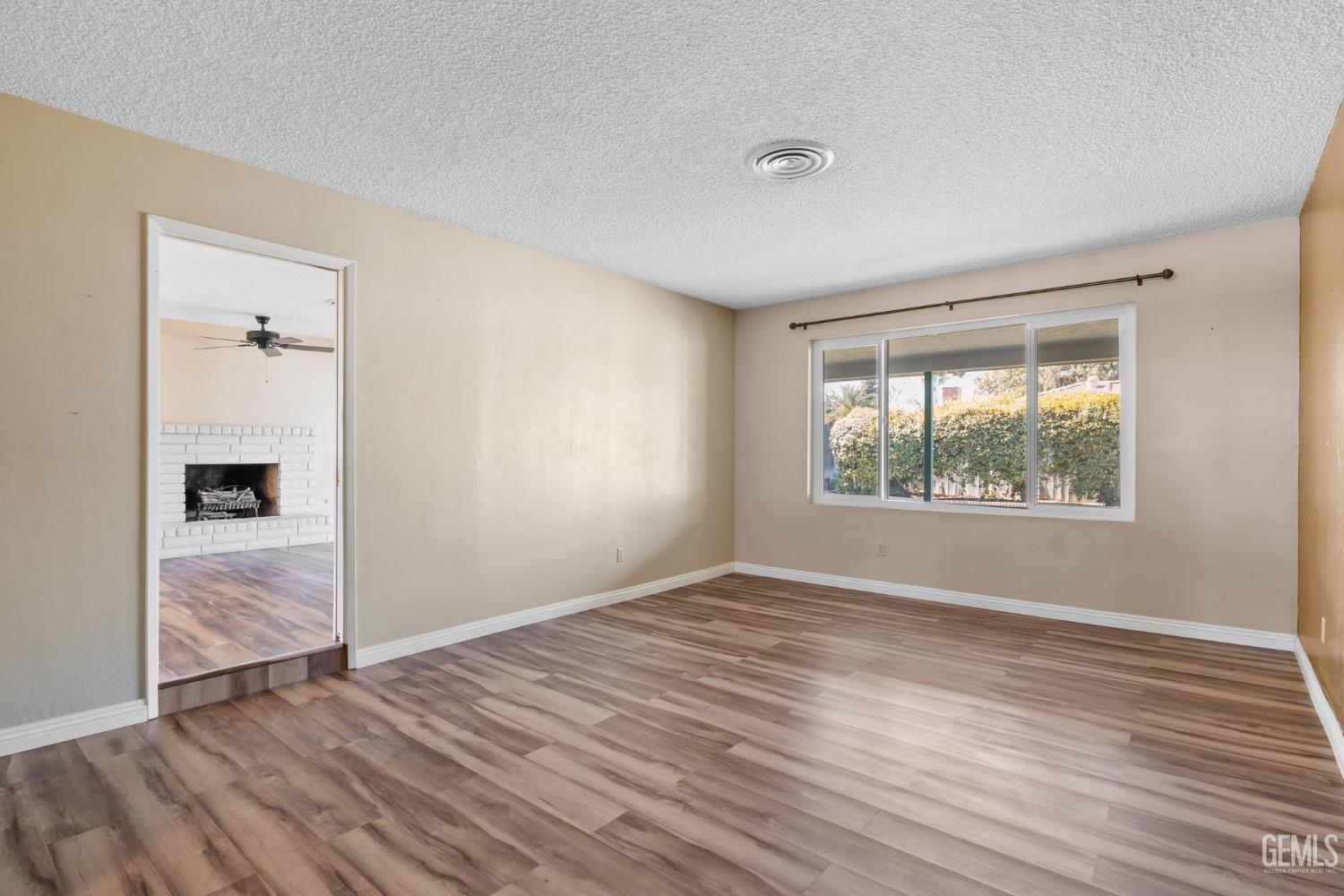 Undisclosed Address Bakersfield, CA 93309 - Photo 42 of 63 an empty room with wooden floor and windows