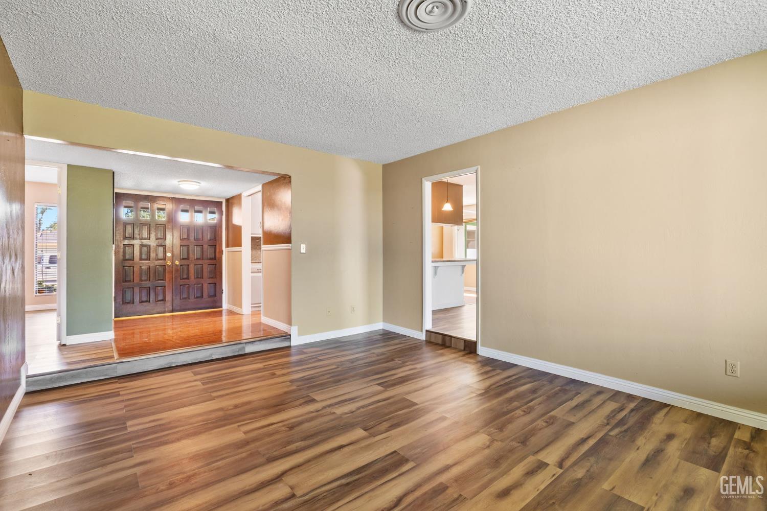 Undisclosed Address Bakersfield, CA 93309 - Photo 44 of 63 a view of an empty room with wooden floor and a window