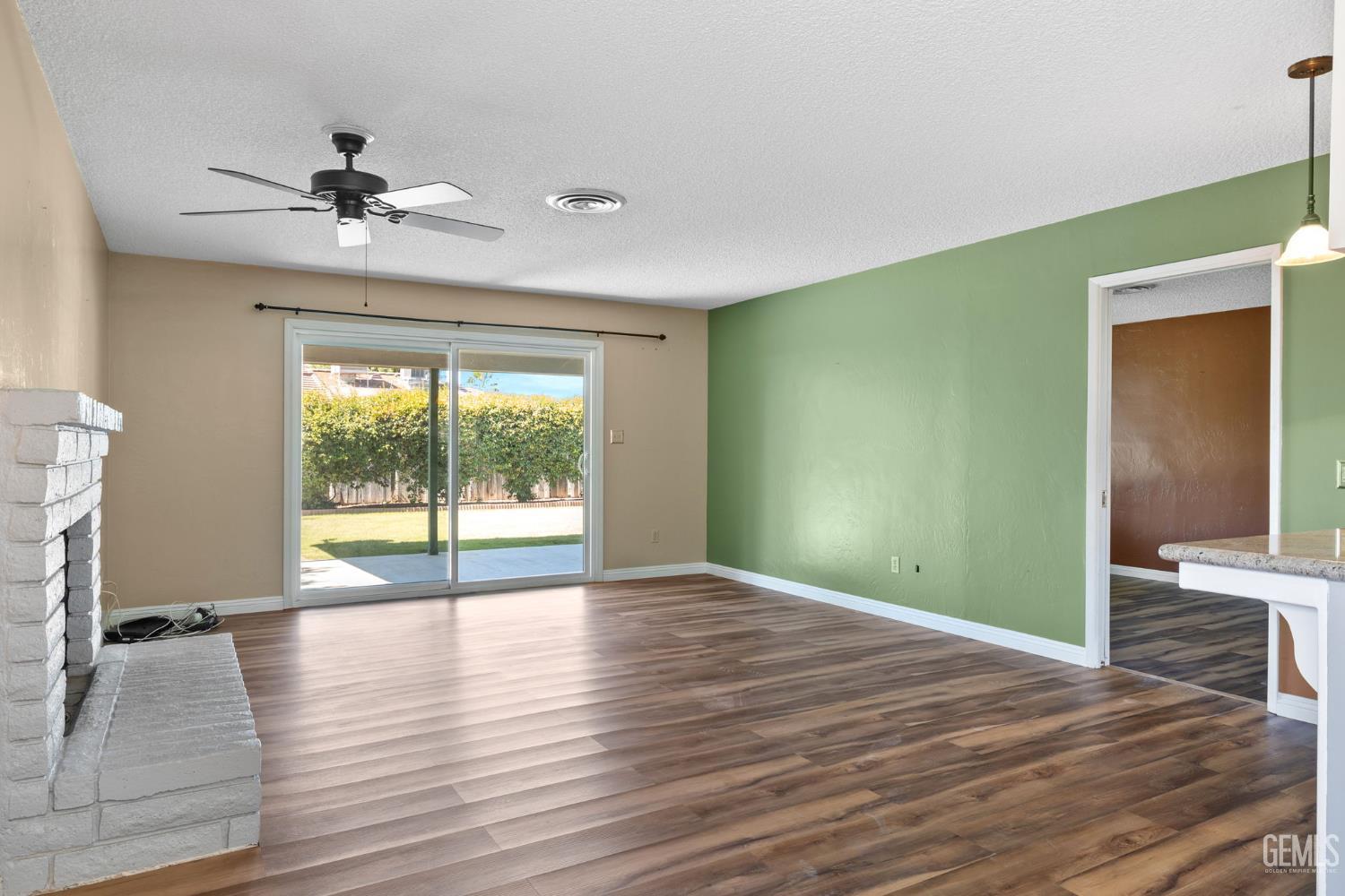 Undisclosed Address Bakersfield, CA 93309 - Photo 46 of 63 a view of an empty room with wooden floor and a window