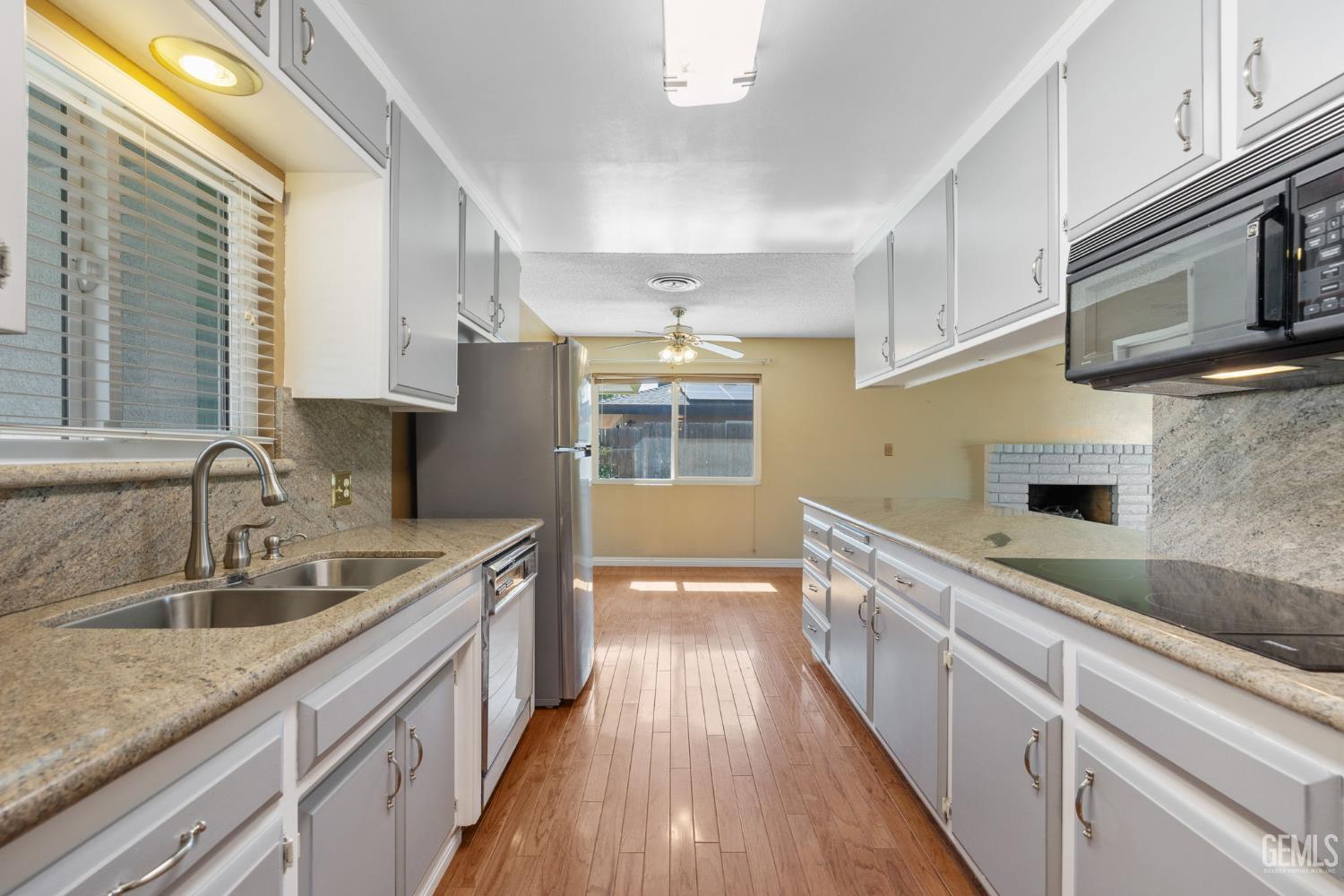 Undisclosed Address Bakersfield, CA 93309 - Photo 50 of 63 a kitchen with stainless steel appliances granite countertop a sink and a stove