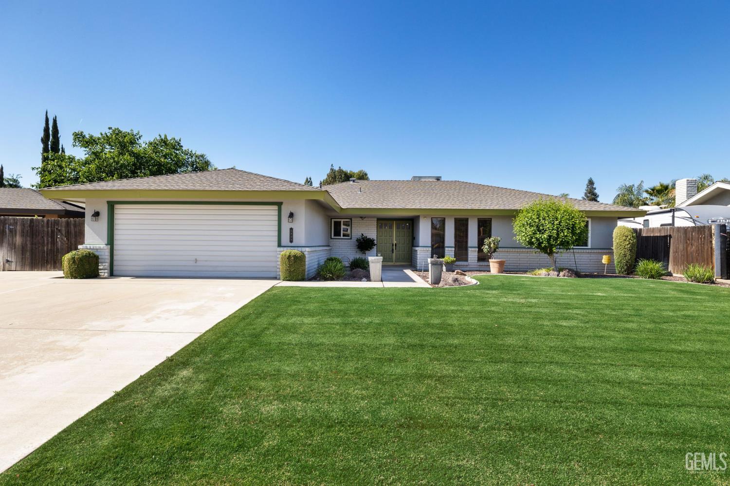 Undisclosed Address Bakersfield, CA 93309 - Photo 5 of 63 a view of a house with a yard potted plants and a large tree