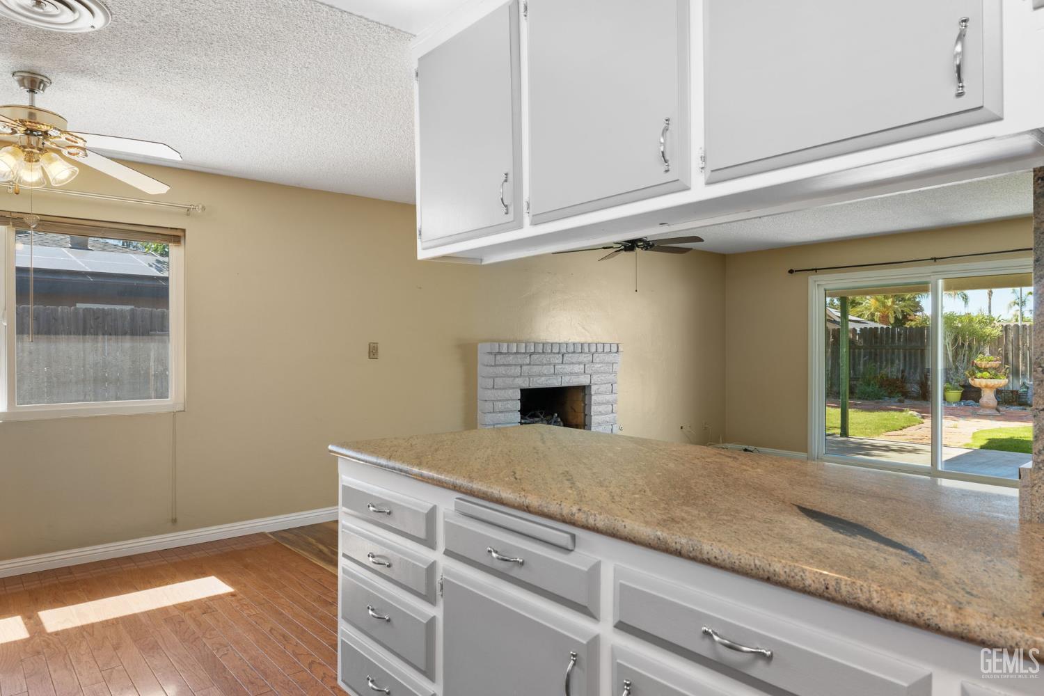 Undisclosed Address Bakersfield, CA 93309 - Photo 51 of 63 a kitchen with granite countertop a sink and dishwasher with white cabinets