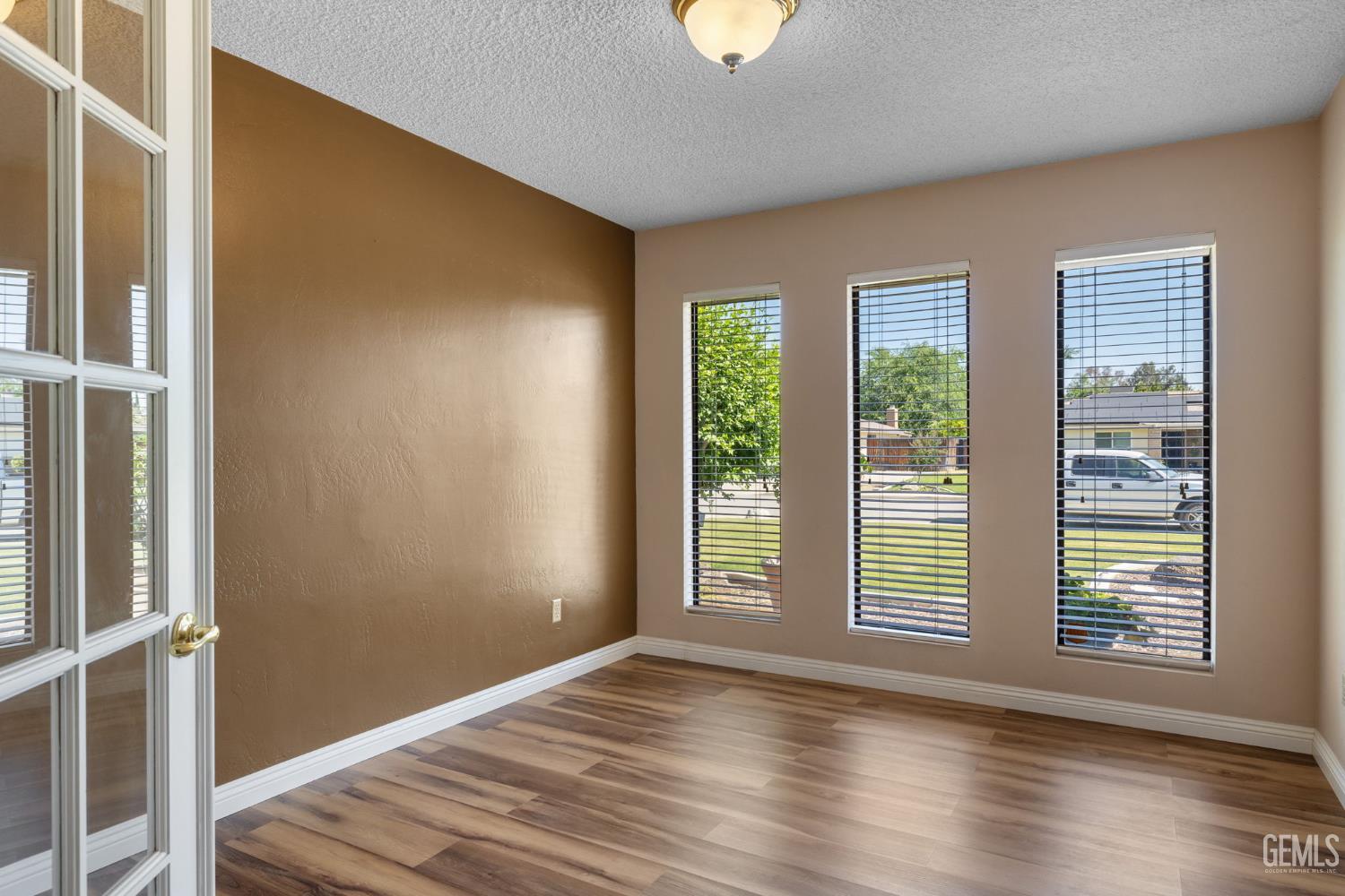Undisclosed Address Bakersfield, CA 93309 - Photo 52 of 63 a view of an empty room with wooden floor and a window