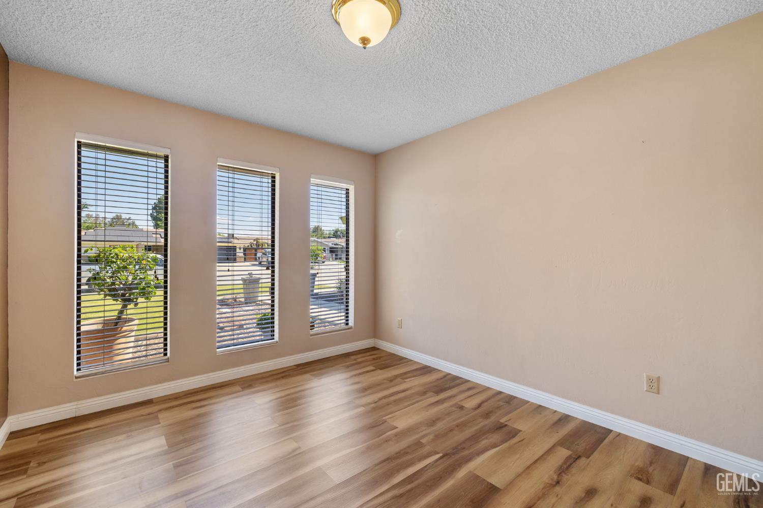 Undisclosed Address Bakersfield, CA 93309 - Photo 53 of 63 a view of an empty room with wooden floor and window
