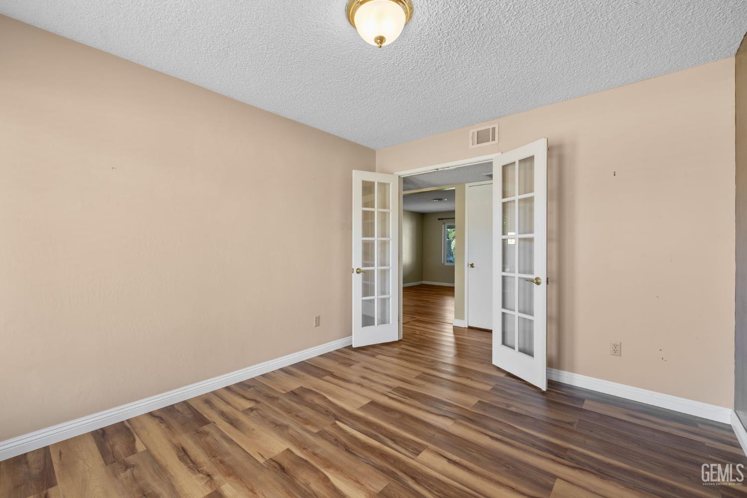 Undisclosed Address Bakersfield, CA 93309 - Photo 54 of 63 a view of an empty room with wooden floor and a window