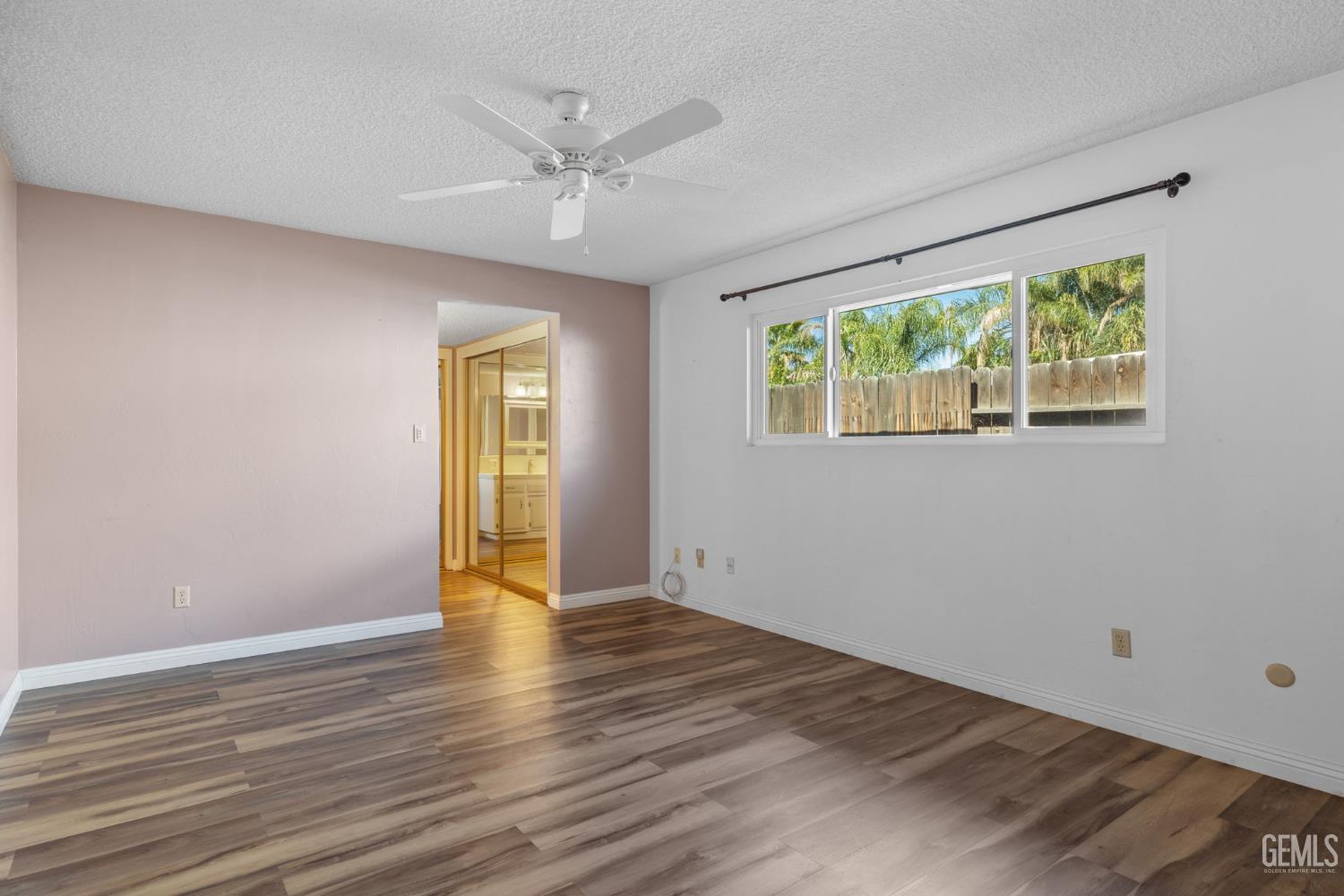 Undisclosed Address Bakersfield, CA 93309 - Photo 55 of 63 a view of an empty room with wooden floor and a window