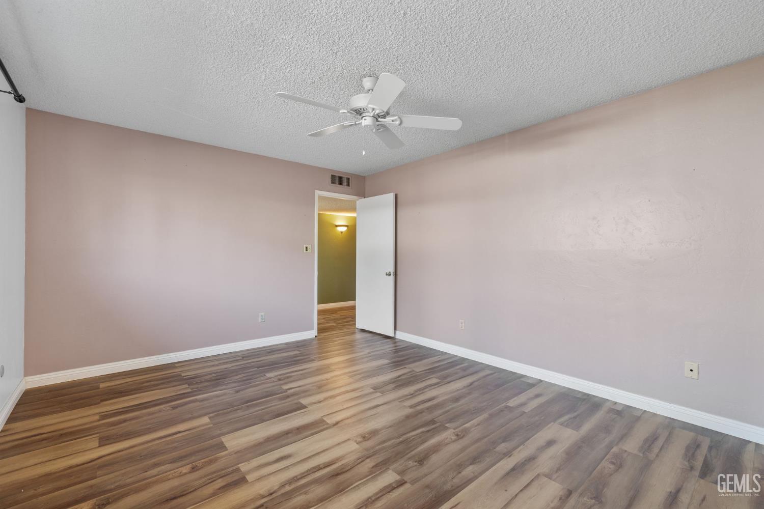 Undisclosed Address Bakersfield, CA 93309 - Photo 57 of 63 a view of an empty room with window and wooden floor
