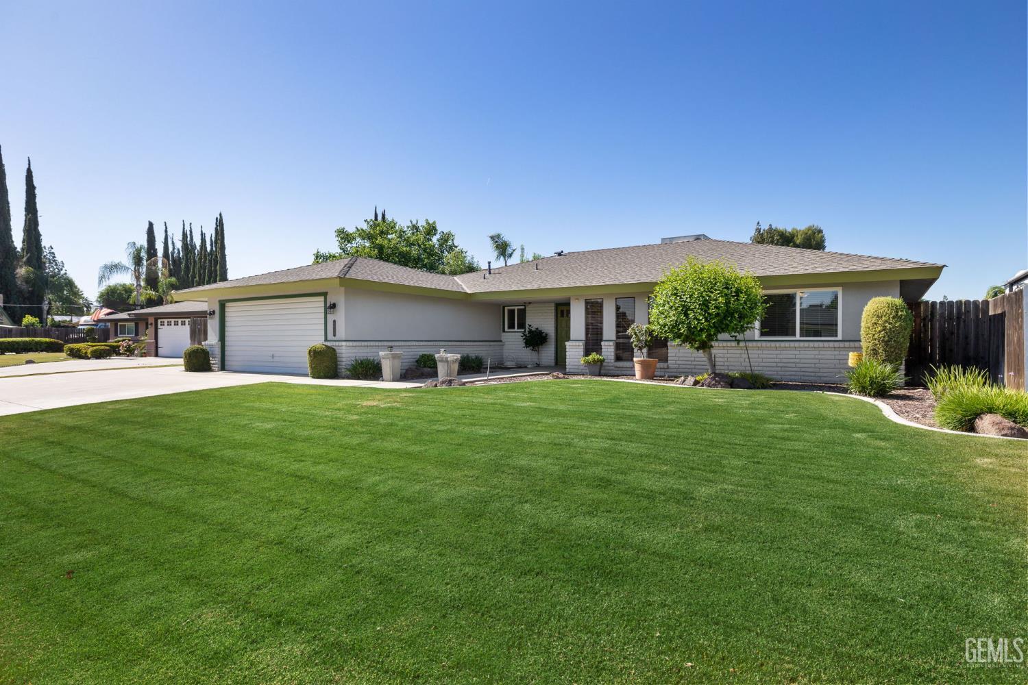 Undisclosed Address Bakersfield, CA 93309 - Photo 7 of 63 a front view of a house with a garden and yard