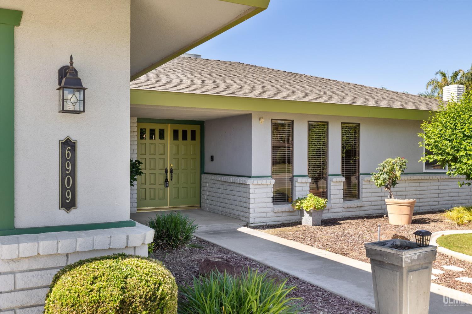 Undisclosed Address Bakersfield, CA 93309 - Photo 8 of 63 a front view of a house with garden