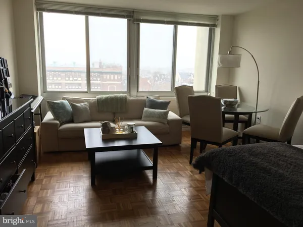 a living room with furniture and a floor to ceiling window